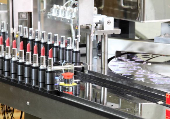 A lipstick packaging machine in a cosmetics factory.